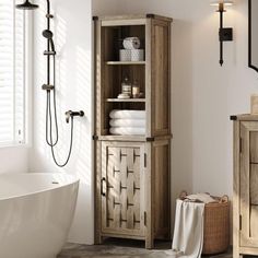 a white bath tub sitting next to a tall wooden cabinet in a bathroom under a window