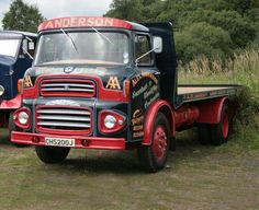 two old trucks parked next to each other