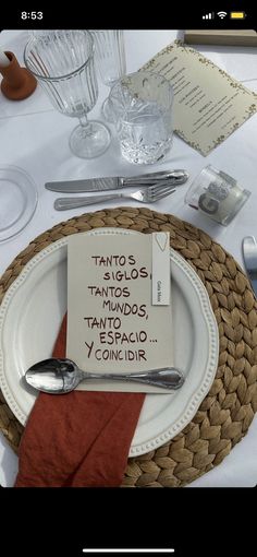 a place setting with silverware, napkins and an empty note on the plate