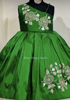 a green dress with white flowers on it