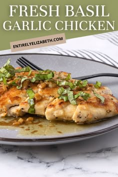 a close up of a plate of food with chicken on it and the words, fresh basil garlic chicken