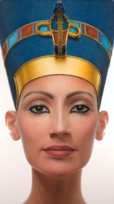 an egyptian woman's head wearing a blue and gold turban with jewels on it