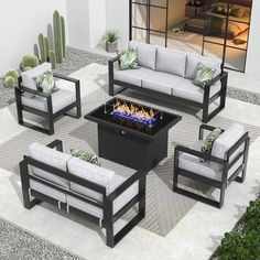 an outdoor fire pit surrounded by couches and chairs with cactus plants in the background