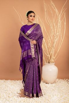 This luxurious Handwoven Pure Zari Silk Kanjivaram saree features a designer pallu crafted with unique Shibori art, offering a sophisticated, exclusive look. Crafted with care, this exquisite saree radiates sophistication and class, creating a stunning statement with subtle artistic elements. Purple Handloom Pre-draped Saree For Puja, Festive Purple Silk Pre-draped Saree, Festive Designer Tussar Silk Pre-draped Saree, Transitional Tissue Silk Pre-draped Saree, Elegant Purple Tissue Silk Pre-draped Saree, Anarkali Tissue Silk Traditional Wear, Festive Silk Pre-draped Saree, Designer Paithani Silk Pre-draped Saree For Festivals, Purple Handloom Pre-draped Saree For Diwali