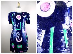 "This trophy dress beautifully embellished with multicolored sequins and accented with beading! Amazing!! It's in excellent condition! Measurements: Bust - 34\" Waist - 29\" Hips - 40\" Length - 35\" Tag Size - Medium This dress comes from a pet-free and smoke-free home. If you would like more info or have any questions, please don't hesitate to ask!" Festival Fitted Sequin Dresses, Fitted Sequin Festival Dresses, Fitted Embellished Festival Dress, Blue Fitted Dress For Festival, Sequin Dresses For Evening Festivals, Purple And Neon Green, Sequined Mini Dress, Mini Dress Blue, Sequin Party