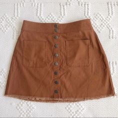 An Easy A-Line Skirt With A Cutoff Hem For A Diy Feel. Patch Pockets And Snaps Give It A Cool Old-School Vibe(Just Right With A Striped Tee Or Tank) Cotton-Elastane Machine Wash Import Brown Cotton Mini Skirt With Pockets, High-waist Brown Skirt With Button Closure, High Waist Brown Skirt With Button Closure, Casual Brown Mini Skirt For Day Out, Brown Cotton Skirt With Buttons, Brown Mini Skirt With Button Closure, Brown Cotton Mini Skirt For Summer, Spring Button-up Brown Skirt, Brown Button Closure Skirt For Summer