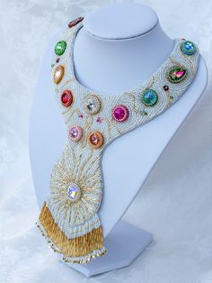 The 'Flowers of the field neckpiece was inspired by the innocent blue sky of the spring, the sparkling, shinig sun and the multicoloured fileds with hundreds of flowers. In this neckpiece I formed the sun with its rays and aery flowers of crystals, bicones and flower shaped beads.  This unique, eyecatching design provides its wearer an outstanding look with the fringes which are dangling freely and sparkingly.  I have used thousands of japanese seedbeads, crystals, Swarovsky bicon beads and Swar Unique Embellished Festival Jewelry, Bohemian Bead Caps Necklace For Party, Elegant Bead Cap Necklaces For Festivals, Elegant Festival Necklace With Bead Caps, Elegant Necklace With Bead Caps For Festivals, Bohemian Embellished Necklaces For Weddings, Swarovski Flowers, Necklace Tutorial, S Hook