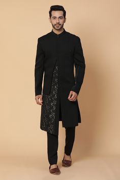 Black sherwani with overlap panels and sequins work. Paired with pant.
Components:2
Pattern:Embroidered
Type of Work:Sequins
Neckline:Band Collar
Sleeve Length:Straight Full
Fabric: Viscose, Silk
Color:Black
Other Details:
Asymmetric panels
Sequins work
Occasion:Reception - Aza Fashions Elegant Festive Bandhgala With Mirror Work, Formal Kurta With Mirror Work For Festive Occasions, Formal Festive Kurta With Mirror Work, Party Sherwani With Dabka In Straight Kurta Style, Party Sherwani With Dabka On Straight Kurta, Elegant Straight Kurta Bandhgala For Party, Festive Elegant Sherwani With Sequins, Formal Sequined Sets For Festivals, Traditional Formal Salwar Kameez With Sequins