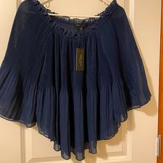 Cute Peasant Style Top In Navy Blue. Has Flared Sleeves With Elastic Neckline For Off The Shoulder. Never Worn With Tags. Size Medium. Billowy Blue Summer Top, Billowy Blue Top For Summer, Summer Billowy Blue Top, Elegant Summer Blouse With Crinkle Texture, Spring Bohemian Blouse With Crinkle Texture, Flowy Crinkle Texture Spring Tops, Chic Blue Billowy Tops, Bohemian Blouse With Crinkle Texture For Spring, Bohemian Crinkle Texture Blouse For Spring