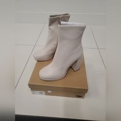 New In Box White Synthetic High Heel Boots, White Synthetic High Heeled Boots, Cream Platform Boots With Block Heel, White Boots With Padded Heel And Medium Width, White Heeled Boots With Padded Heel, Medium Width, White Heeled Boots With Padded Heel, Beige Synthetic Ankle Boot Heels, White Synthetic Boots With Padded Heel, White Padded Heel Ankle Boots