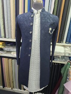 Introducing the epitome of elegance and sophistication, our exquisite Navy Blue Embroidered Sherwani. Crafted with meticulous attention to detail, this sherwani is a true masterpiece that will make you stand out on any special occasion. The navy blue fabric is adorned with intricate floral embroidery, creating a stunning visual appeal. The embroidery is meticulously hand-stitched, showcasing the artistry of our skilled craftsmen. The sherwani features a classic mandarin collar, adding a touch of modern refinement.  The sherwani is designed to provide a comfortable and flattering fit. It is tailored to perfection, ensuring a sharp and elegant silhouette. The soft and breathable fabric allows for maximum comfort throughout the day or night.  Our navy blue embroidered sherwani is a timeless p Designer Traditional Wear With Cutdana For Reception, Traditional Silver Kurta For Wedding, Designer Brocade Sets For Eid, Traditional Drape Sets For Eid Ceremony, Eid Ceremony Sets With Traditional Drape, Designer Brocade Traditional Wear With Traditional Drape, Designer Brocade Traditional Wear, Ceremonial Elegant Bandhgala With Dupatta, Elegant Ceremonial Bandhgala With Dupatta