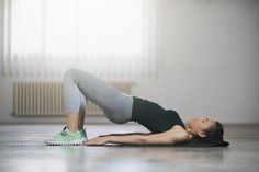 a woman is doing yoga on the floor