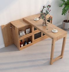 a wooden table with two shelves on each side and a potted plant next to it