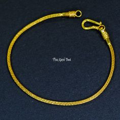 a yellow rope bracelet on a black surface