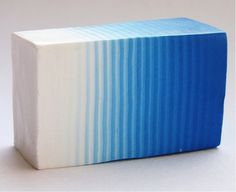 a blue and white soap bar sitting on top of a table