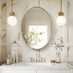 a bathroom with marble counter tops and gold fixtures on the wall, along with a round mirror