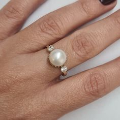 Engagement Gold ring, 14k Gold ring, Gold ring with pearl, ivory pearl gold ring, bridal pearl ring, bridesmaid gift This Shell handmade Gold ring with Pearl is made of 14K genuine gold and set with Natural Pearl. This Stunning Ring is set with Best AAA+ Quality Natural Pearl set in 14k Yellow Gold. High end finish with easy touch of diamond cut. This 14k Gold ring can serve as an engagement ring or a birthday gift. All colors at the picture are available. * Gemstone -8mm Round Natural Pearl. * Elegant Halo Ring With Round Band As Gift, Elegant Pearl Ring With Bezel Setting For Formal Occasions, Elegant Pearl Ring With Bezel Setting For Formal Events, Elegant Round Halo Ring With Bezel Setting, Elegant Formal Pearl Ring With Bezel Setting, Gold Pearl Ring With Halo Setting For Gift, Classic Round Pearl Ring With Halo Design, Classic Pearl Ring With Halo Design, 14k Gold Pearl Ring With Prong Setting For Promise