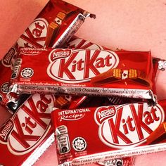 a pile of kitkat chocolate bars sitting on top of each other