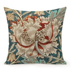 a blue and red pillow with an intricate flower design on the front, sitting on a white background