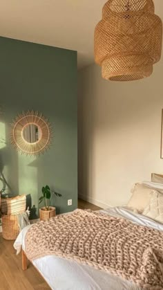 a bed room with a neatly made bed and two wicker baskets hanging from the ceiling