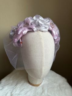 "This is a vintage 1950s purple fascinator with purple tulle birdcage veil, velvet bow and faux floral details. This piece is in good vintage condition, with small deep orange spots on internal wiring wrapped in purple velvet due to age and wear. Minimal staining can be viewed from outside of fascinator. Length: 12\" / Width: 7\" ALL SALES ARE FINAL. Unless otherwise stated all vintage items are used and may have minor to moderate wear or discoloration considering the age of the item. Most items Vintage Handmade Flowers Fascinator For Party, Purple Headband With Handmade Flowers, Purple Handmade Flowers Headband, Spring Wedding Lavender Headpiece, Purple Headpiece With Handmade Flowers For Kentucky Derby, Purple Handmade Flowers Headpiece For Kentucky Derby, Purple Fascinator With Handmade Flowers For Parties, Purple Fascinator With Handmade Flowers For Spring, Purple Spring Fascinator With Handmade Flowers