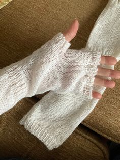 Hand knitted white fingerless arm warmers.  Designed to keep arms and hands warm both indoors and out and keep fingers free.  The ribbing is not too tight so it will fit over the elbows and not fall down but won't be uncomfortable.   Knitted in machine washable yarn in white (more colours coming) and made to fit an adult of medium size. Will fit under or over a top. White Stretch Warm Leg Warmers, Cozy White Leg Warmers, Cozy Comfortable White Leg Warmers, White Stretch Leg Warmers, White Stretch Knitted Leg Warmers, Fitted White Knit Knitting Pattern, White Stretch Knit Leg Warmers, White Soft Warm Leg Warmers, Soft White Warm Leg Warmers