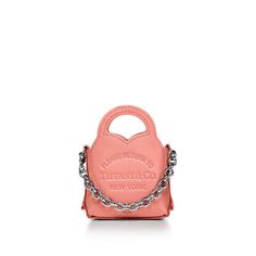 Inspired by one of the House’s most distinctive designs, the heart-shaped Return to Tiffany™ handbags are crafted in supple leather and embellished with a chain link accent that nods to our iconic jewelry. Add a playful touch to every day with this nano bag. It’s embossed with our signature heart motif and features a detachable chain on one side. Almond pink semi-ponge leather; Palladium-plated hardware; 3" W x 4" H x 1" D; Comes with a dust bag; Made in Italy | Return to Tiffany™ Nano Bag in Almond Pink Leather Iconic Jewelry, Heart Motif, In My Bag, My Bag, Pink Leather, Tiffany & Co., Chain Link, Women's Accessories, Almond