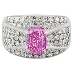 Intricately paired together, this pink sapphire and diamond ring boasts an exceptionally colored oval cut 2 carat Pink Sapphire center stone. Surrounded by a cluster of round cut white diamonds, the ring itself is made from 18k white gold. Dome shank and cluster setting offer excellent coverage on the finger. The Sapphire and diamonds are 100% natural, mined gemstones. Set in 18k solid white gold. Item Details: - Type: Cluster Ring - Metal: 18K White Gold - Weight: 10.4 Grams - Setting: Prong, P Round Sapphire, Sapphire And Diamond Ring, Dome Ring, Argentium Silver, Domed Ring, Ring Metal, Diamond Cluster, 2 Carat, Sapphire Diamond