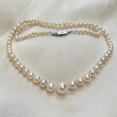 A beautiful graduated pearl necklace, on a vintage silver and pearl clasp. * 3mm - 7mm cultured Akoya pearls * hand knotted * 18ct white gold safety clasp * 17" necklace length (not your size? Message me.) Lovely quality classic cultured Akoya pearls with a beautiful bright lustre and pink undertones. These pearls are perfectly round and have hardly any flaws in their nacre. I have hand knotted between each of these gorgeous pearls and attached them to an 18ct white gold, hook in safety clasp. T Classic Single Strand Pearl Necklace With Round Beads, Classic Akoya Pearl Necklace, Classic Single Strand Pearl Necklace For Anniversary, Classic Single Strand Round Pearl Necklace, Classic Single Strand Pearl Necklace, Classic Pearl Necklace With Round Pearl Drop, Classic Pearl Necklace With Round Beads And Pearl Drop, Classic Pearl Necklace With Round Beads For Anniversary, Classic Pearl White Necklace With Sterling Silver Clasp