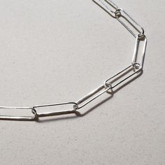 This is an image of a 20 sterling silver paperclip chain necklace by Jennifer Favour. This chain is long and lightweight and has a lobster clasp closure. Minimalist Paperclip Chain Necklace As Gift, Minimalist Paperclip Chain Necklace For Gift, Minimalist Paperclip Chain Necklace Gift, Minimalist Everyday Cable Chain Necklace, Simple Silver Chain Necklace For Everyday, Silver Simple Chain Necklace For Everyday, Everyday Minimalist Cable Chain Necklace, Silver Link Paperclip Bracelet As Gift, Minimalist Silver Chain Paperclip Bracelet As Gift