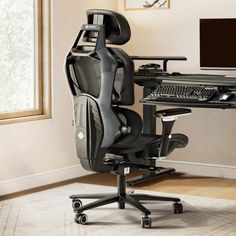 a computer chair sitting in front of a desk with a monitor and keyboard on it