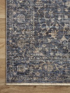 an area rug with blue and beige colors