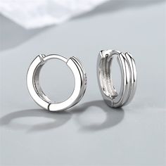 Finish your ensembles with these layered huggie earrings showcasing shiny silver-plated frames. 0.63" diameter Silver-plated copper Silver Huggie Earrings For Pierced Ears, Nickel-free Silver Huggie Earrings, Silver Metal Huggie Earrings For Formal Occasions, Formal Silver Metal Huggie Earrings, Formal Silver Small Hoop Huggie Earrings, Silver Jewellery Earrings, Line Earrings, Huggie Earrings Gold, Womens Jewellery