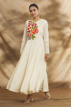 Cream Anarkali featuring floral embroidery on the yoke and cutwork detailing, Fit: Relaxed Chanderi Kurta With Floral Embroidery In Maxi Length, Anarkali Kurta With Embroidered Border, Cotton Silk Churidar With Embroidered Border, Long Sleeve Chanderi Anarkali Set With Embroidered Border, Cotton Silk Anarkali Set With Embroidered Border, Floral Embroidered Anarkali Set For Navratri, Anarkali Set With Floral Embroidery For Navratri, Floral Embroidery Anarkali Set For Navratri, Transitional Season Anarkali Dress In Off White