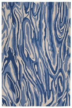 a blue and white area rug with wavy lines on the top, in an abstract manner