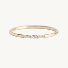 a yellow gold ring with three diamonds on it