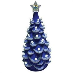 a blue glass christmas tree with white and silver decorations