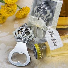 a bottle opener is sitting next to some yellow flowers and a card with a skeleton on it