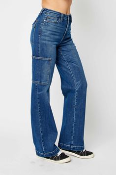 Expertly designed and crafted with a high waist and wide leg, the Judy Blue High Waist Wide Leg Cargo Jeans provide a stylish and comfortable fit. These jeans are made with high-quality materials for durability and feature practical cargo pockets for added functionality. Elevate your denim collection with these versatile and trendy jeans. Details:- High Waist- Wide Leg- Cargo Style with 6 Pockets Total- Lightly Stretchy Fabric Content:- 94% Cotton, 5% Polyester, 1% Spandex Utility Flare Jeans With Five Pockets In Denim Blue, Denim Blue Utility Flare Jeans, Fall Utility Flare Jeans In Medium Wash, Fall Utility Style Medium Wash Flare Jeans, Medium Wash Wide Leg Utility Flare Jeans, Utility Style Medium Wash Wide Leg Flare Jeans, Utility Style Wide Leg Flare Jeans In Medium Wash, Fall Wide Leg Medium Wash Cargo Jeans, Washed Blue Wide Leg Cargo Jeans