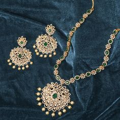 Description: This marvelous CZ necklace set by Tarinika is as timeless as it is radiant. Both necklace and earrings display a beautiful arrangement of high-quality CZ stones, glittering brilliantly in the form of florals. Perfect to accentuate wedding outfits with an elegant touch, this necklace set can be combined with matching pieces of Tarinika CZ jewelry for a grand loyal look. Details & Specifications: Materials used: CZ Stone with Yellow Gold Plating Weight - Necklace 66.5 gms, Earrings 34 Festive Diamond Jewelry Sets For Reception, Reception Jewelry Sets With Intricate American Diamond Design, Festive Diamond Jewelry Sets With Stone Work, Elegant Stone Work Necklace For Eid, Elegant Zari Work Necklace For Eid, Dazzling Jewelry Sets For Festive Reception, Festive Cubic Zirconia Jewelry Sets For Reception, Dazzling Bridal Necklace For Reception, Elegant Bridal Earrings With Zari Work For Diwali