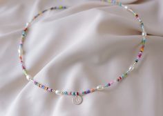 Precious and Colorful Initial Choker Necklace. Perfect as a gift or a beautiful piece to wear in this season of the year    ♡ Beads: Colorful Seed Chaquira.   ♡ High Quality Pearls Grade AAA    ♡ Silver Beads and components: .925 Sterling Silver   ♡ Hypoallergenic   ♡ Long Lasting   ♡ 1in Extender PEARLS: Grade AAA is the Highest Quality of non-round shape pearls.          C A R E ∙ T I P S To maintain the Perfect Quality of your new Velvet Collection Necklace, please: * Wash your necklace with Colorful Letter Beads Necklace Gift, Rainbow Letter Beads Necklaces For Summer, Multicolor Tiny Beads Jewelry For Birthday, Rainbow Letter Beads Necklace For Summer, Rainbow Colored Letter Beads Necklace For Summer, Colorful Handmade Necklace For Birthday, Summer Rainbow Letter Beads Necklaces, Summer Rainbow Letter Beaded Necklaces, Personalized Multicolor Bohemian Necklace