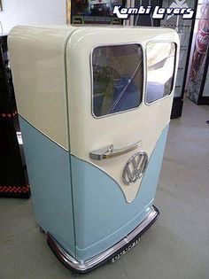 an old blue and white car parked in a garage