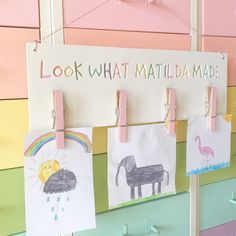 colorful wall hangings with clothes pins and pictures on them that say, look what matilda made