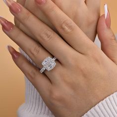 a woman's hand with a diamond ring on it