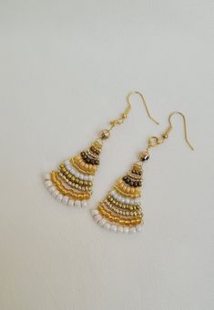 Discover elegance with my exquisite handmade beaded earrings, perfect for adding a touch of sophistication to any outfit. Each pair is unique and reflects both artistry and style. Whether you're dressing up for a special occasion or looking to elevate your everyday ensemble, my beaded earrings are versatile and chic. They make a wonderful gift for someone special or a delightful treat for yourself. Gold Beaded Earrings For Celebration, Elegant Beaded Earrings With Dangling Beads For Festive Occasions, Elegant Adjustable Beaded Earrings With Colorful Beads, Elegant Handmade Adjustable Beaded Earrings, Adjustable Round Beaded Earrings For Festive Occasions, Elegant Adjustable Colorful Beaded Earrings, Elegant Beaded Earrings For Celebration, Beaded Earrings With Round Beads For Celebration, Elegant Gold Earrings With Tiny Beads