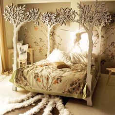 a bed with white trees on the headboard and foot board in front of it