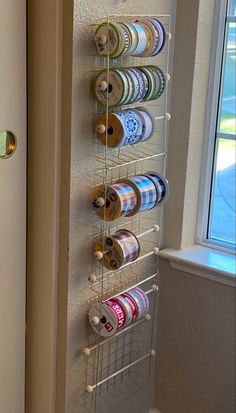 a wall mounted spice rack holding several different types of spices