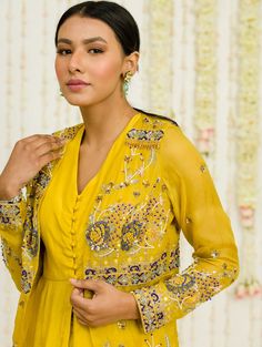 Editor's Note Mustard Hand Embroidered Jacket With Matching Peplum And Sharara In Crepe Fabric: Crepe, Organaza Color: Mustard Care: Dry Clean Only About the Designer Sanya Gulati's designs are inspired by the Indian bridesmaids, pastel easy hues & seasonal trends, her designs are a mix of modern, contemporary embroideries with traditional silhouettes thus creating our signature asymmetric checks embroideries amalgamated with floral thread work, through her designs, the designer aims to enhance Anarkali Set With Long Sleeve And Floral Embroidery, Yellow Long Sleeve Anarkali Set For Transitional Season, Transitional Yellow Anarkali Set With Long Sleeves, Transitional Yellow Long Sleeve Anarkali Set, Diwali Long Sleeve Anarkali Set With Intricate Embroidery, Designer Long Sleeve Anarkali Set With Floral Embroidery, Designer Floral Embroidered Long Sleeve Anarkali Set, Bohemian Long-sleeve Anarkali Set For Festive Occasions, Designer Long Sleeve Floral Embroidery Anarkali Set