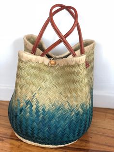 These beautiful pieces are designed in South Africa. Handmade with raffia and featuring leather handles, these bags bring the perfect mix of bohemian chic to everyday wear! Capable of being used as a handbag, basket or storage-this multi-purpose piece is a cannot miss! The double closure top provides a multi-style capability as well! Sizing: 16 inches wide x 12 inches deep x 13 inches high Bohemian Natural Bucket Bag For Daily Use, Bohemian Brown Beach Bag With Handles, Bohemian Hobo Bag With Braided Double Handles, Bohemian Bucket Bag With Braided Top Handle, Natural Bags With Leather Handles, Palm Leaf Bucket Bag For Market, Multicolor Hobo Bag With Braided Handles For Beach, Natural Bags With Leather Handles For Market, Natural Bucket Bag With Braided Handles For Market