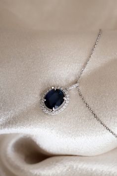 Blue Sapphire Oval Cut Pendant with a Diamond Halo. Pendant is by Diamond and Gold Warehouse in Dallas, Texas. Dazzling Blue Necklace With Brilliant Cut, Elegant Blue Diamond Pendant Necklace, Blue Diamond Necklace For Formal Occasions, Blue Luxury Diamond Necklace For Anniversary, Luxury Blue Diamond Necklace For Anniversary, Luxury Blue Diamond Necklace For Formal Occasions, Blue Diamond Necklace For Wedding, Elegant Blue Diamond Necklace For Wedding, Sapphire Diamond Cut Necklace For Weddings